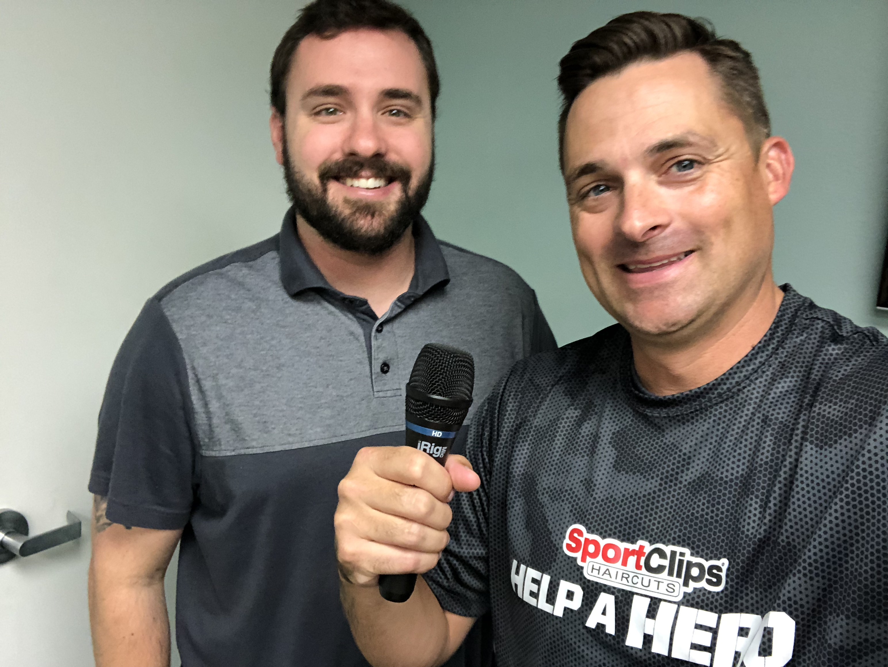 Chad and Adam Lawrence holding a microphone